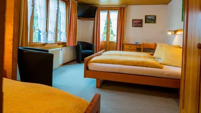 Ein Bett oder Betten in einem Zimmer der Unterkunft Swiss Lodge Joopi
