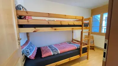 Ein Bett oder Betten in einem Zimmer der Unterkunft 250m zur Hannigalp und Bergpanorama