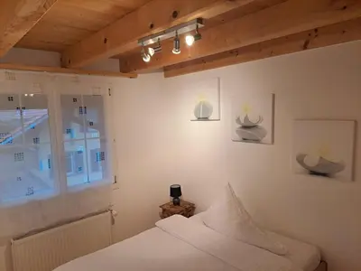 Ein Bett oder Betten in einem Zimmer der Unterkunft Family-friendly apartment with Alpine view