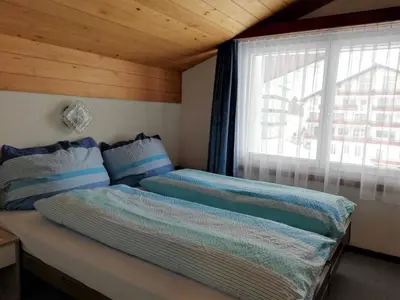 Ein Bett oder Betten in einem Zimmer der Unterkunft Apartment Floralpina by Interhome