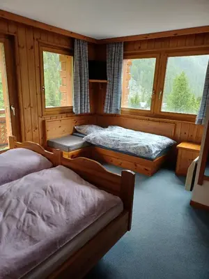 Ein Bett oder Betten in einem Zimmer der Unterkunft Hôtel Garni Les Bouquetins