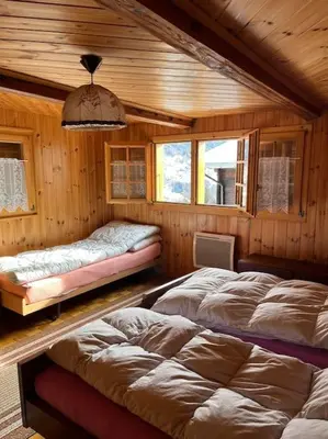 Ein Bett oder Betten in einem Zimmer der Unterkunft Chalet 3 pièces de caractère