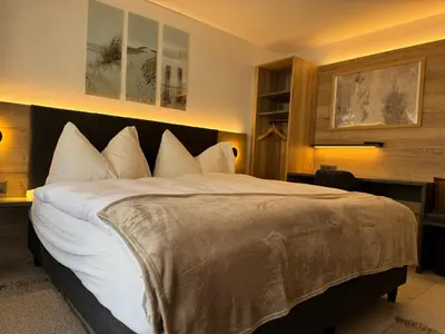 Ein Bett oder Betten in einem Zimmer der Unterkunft Ferienwohnungen Eden und Simonella
