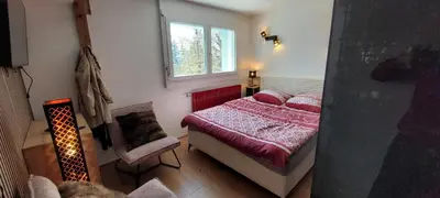 Ein Bett oder Betten in einem Zimmer der Unterkunft Chez Claudine et Charles - Crans-Montana