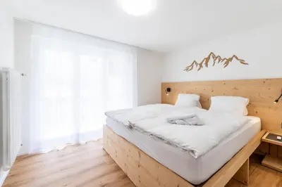Ein Bett oder Betten in einem Zimmer der Unterkunft Alpines Bijou-Meiji Haus Juliana an der Bergbahn