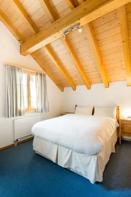 Ein Bett oder Betten in einem Zimmer der Unterkunft HOSPENTAL Chalet
