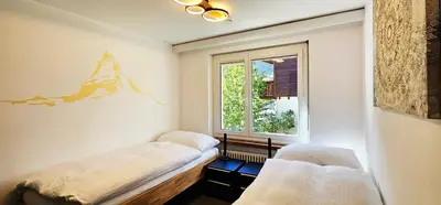 Ein Bett oder Betten in einem Zimmer der Unterkunft Capri Matterhorn View