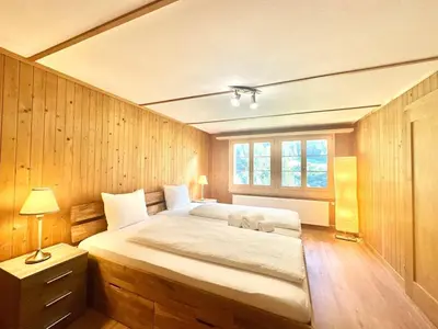 Ein Bett oder Betten in einem Zimmer der Unterkunft Scenic Stay Grindelwald Interlaken & Lauterbrunen