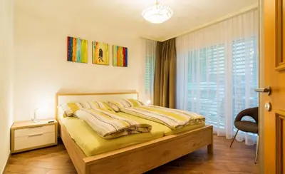 Ein Bett oder Betten in einem Zimmer der Unterkunft Residenz Ambassador B13 mit Wellness-Fitness