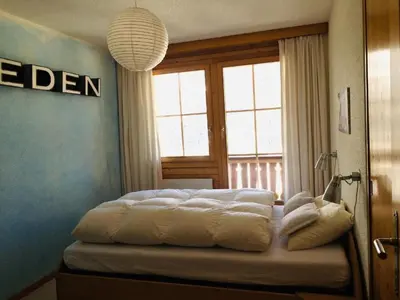 Ein Bett oder Betten in einem Zimmer der Unterkunft Apartment Chalet Sunnsyta by Interhome
