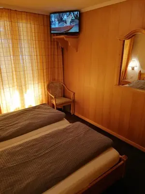 Ein Bett oder Betten in einem Zimmer der Unterkunft Petit Helvetia Budget Hotel