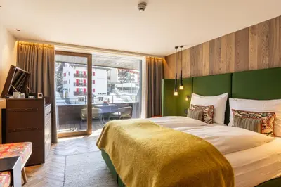 Ein Bett oder Betten in einem Zimmer der Unterkunft Hotel ZERMAMA Zermatt