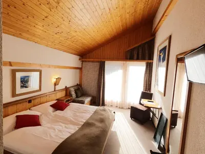 Ein Bett oder Betten in einem Zimmer der Unterkunft Hôtel Cristal - Swiss Riders Lodge Grimentz