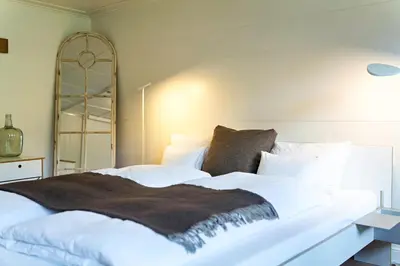 Ein Bett oder Betten in einem Zimmer der Unterkunft Lenk Lodge - Boutique & Design Hotel und Apartements