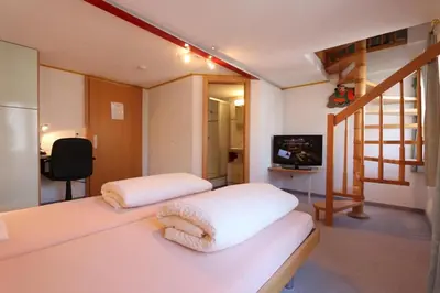 Ein Bett oder Betten in einem Zimmer der Unterkunft Hotel Alpina