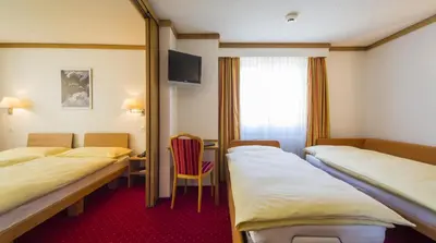 Ein Bett oder Betten in einem Zimmer der Unterkunft Hotel Excelsior