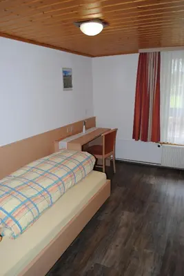 Ein Bett oder Betten in einem Zimmer der Unterkunft Hotel Des Alpes
