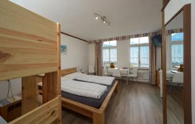 Ein Bett oder Betten in einem Zimmer der Unterkunft Swiss Lodge Hotel Bernerhof