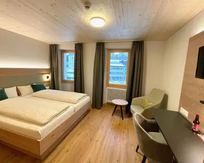 Ein Bett oder Betten in einem Zimmer der Unterkunft Boutique und Bier Hotel des alpes