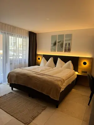 Ein Bett oder Betten in einem Zimmer der Unterkunft Hotel und Appartments Eden
