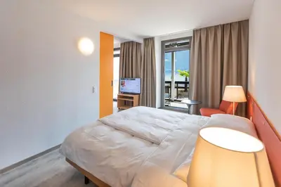 Ein Bett oder Betten in einem Zimmer der Unterkunft Parkhotel Brenscino Brissago