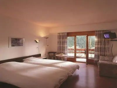 Ein Bett oder Betten in einem Zimmer der Unterkunft Hotel du Pigne