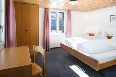Ein Bett oder Betten in einem Zimmer der Unterkunft Berghaus Männlichen