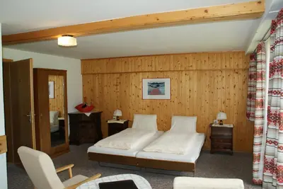 Ein Bett oder Betten in einem Zimmer der Unterkunft Hotel Pension Spycher