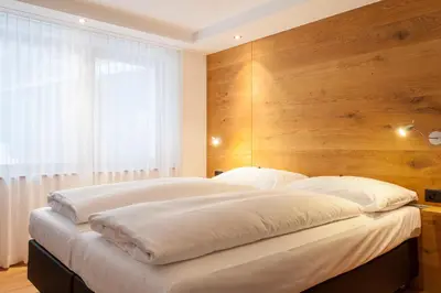 Ein Bett oder Betten in einem Zimmer der Unterkunft Elite Alpine Lodge - Apart & Breakfast
