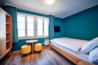Ein Bett oder Betten in einem Zimmer der Unterkunft 5th Floor Basic Rooms - shared bathrooms
