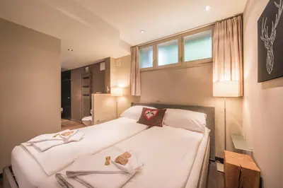 Ein Bett oder Betten in einem Zimmer der Unterkunft Schweizerheim Residence 11