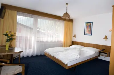 Ein Bett oder Betten in einem Zimmer der Unterkunft Hotel Alpha