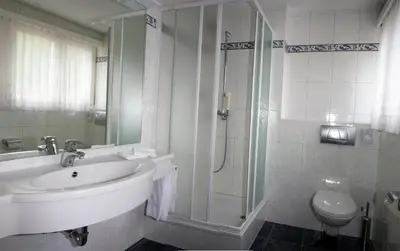 Ein Badezimmer in der Unterkunft Hotel Alpha