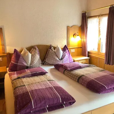 Ein Bett oder Betten in einem Zimmer der Unterkunft Alpina