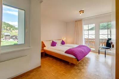 Ein Bett oder Betten in einem Zimmer der Unterkunft Bacchus Saas-Fee
