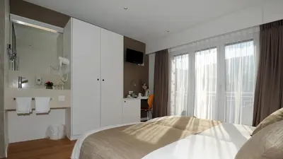 Ein Bett oder Betten in einem Zimmer der Unterkunft Hôtel Elite