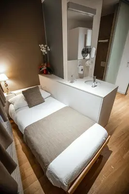 Ein Bett oder Betten in einem Zimmer der Unterkunft Hôtel Elite