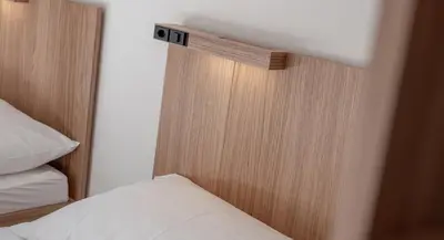 Ein Bett oder Betten in einem Zimmer der Unterkunft Sport Resort Fiesch, Garni Goneri