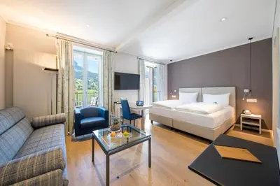 Ein Bett oder Betten in einem Zimmer der Unterkunft Belvedere Swiss Quality Hotel