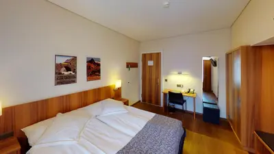 Ein Bett oder Betten in einem Zimmer der Unterkunft Hotel Ambassador