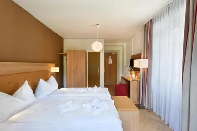 Ein Bett oder Betten in einem Zimmer der Unterkunft Waldhotel Unspunnen
