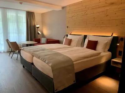 Ein Bett oder Betten in einem Zimmer der Unterkunft Hotel Interlaken