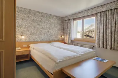 Ein Bett oder Betten in einem Zimmer der Unterkunft Hotel Metropol & Spa Zermatt