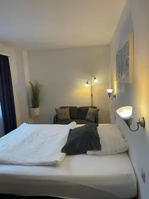 Ein Bett oder Betten in einem Zimmer der Unterkunft Hotel Europe Brig