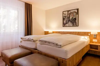 Ein Bett oder Betten in einem Zimmer der Unterkunft Golfhotel Riederhof