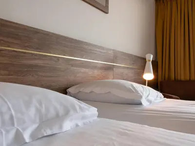 Ein Bett oder Betten in einem Zimmer der Unterkunft Hotel-Restaurant Le Mont Paisible, Crans-Montana
