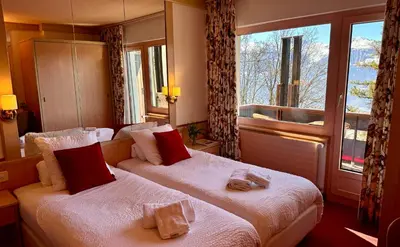 Ein Bett oder Betten in einem Zimmer der Unterkunft Hôtel de la Forêt