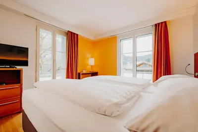 Ein Bett oder Betten in einem Zimmer der Unterkunft Parkhotel Schoenegg