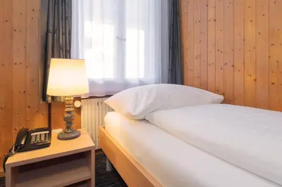 Ein Bett oder Betten in einem Zimmer der Unterkunft Jungfrau Lodge, Swiss Mountain Hotel