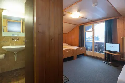 Ein Bett oder Betten in einem Zimmer der Unterkunft Jungfrau Lodge, Swiss Mountain Hotel